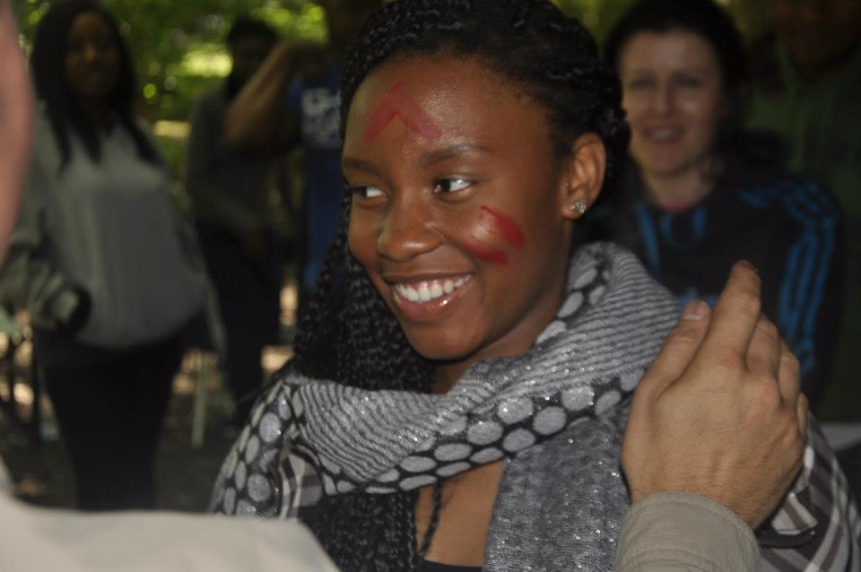 Earning her stripes during a rite of passage celbration. This young lady is beaming with pride!