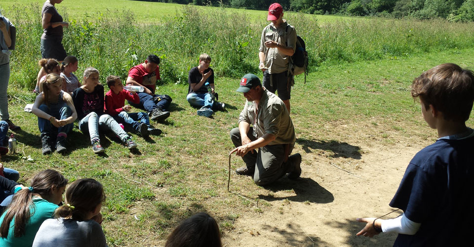 Navigating using sticks and shadows! The group is finding out how from one of the instructors.